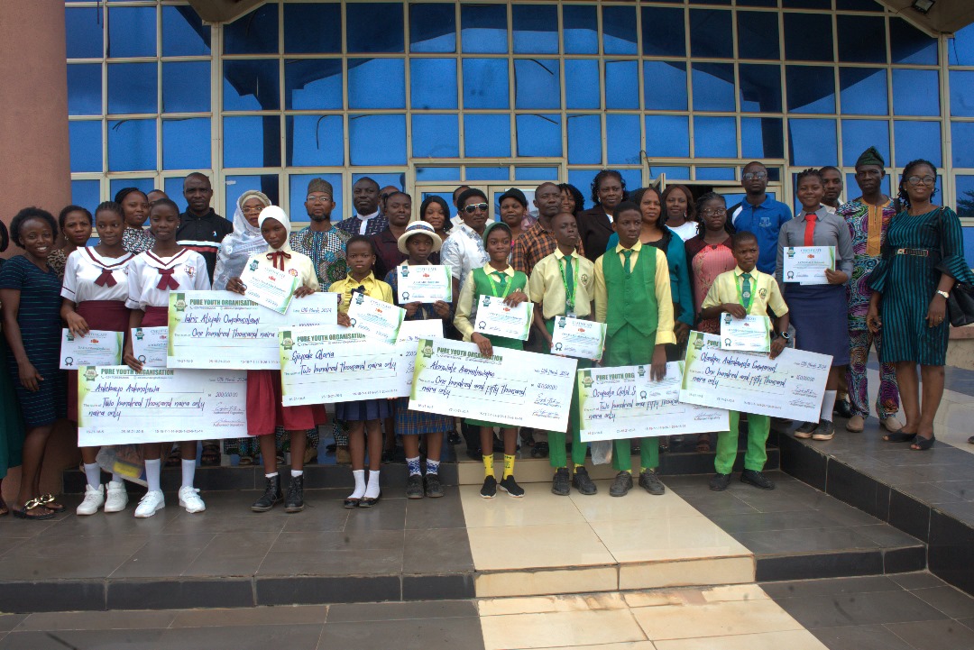 PYO Essay Competition 2024 prize-giving — all winners with organisers and oversized cheques