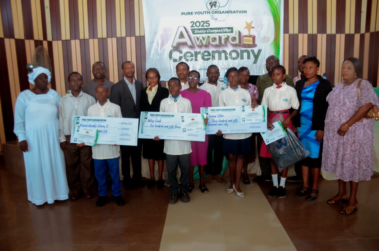 PYO Essay Competition 2025 award ceremony — junior secondary winners holding cheques